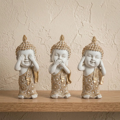 Trío de Budas decorativos en tonos crema y dorado, ideales para ambientes minimalistas y luminosos.